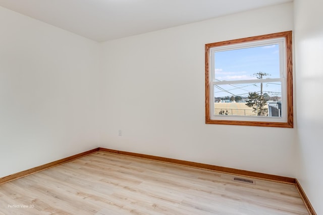 spare room with light hardwood / wood-style flooring