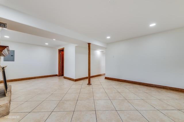 basement with light tile patterned floors and electric panel