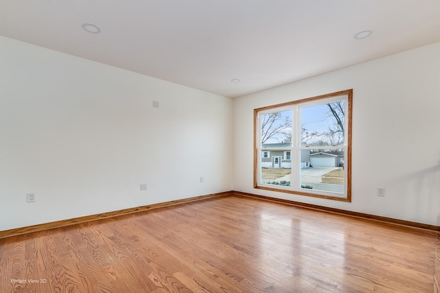 spare room featuring light hardwood / wood-style flooring