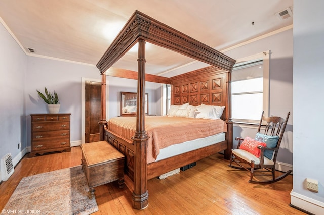 bedroom with light hardwood / wood-style flooring and ornamental molding