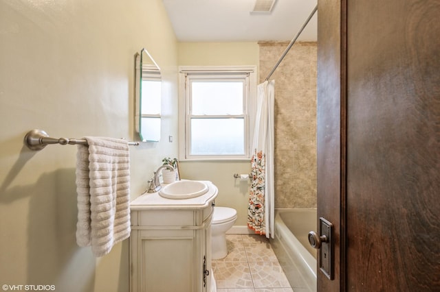 full bathroom featuring tile patterned floors, toilet, vanity, and shower / bath combo with shower curtain