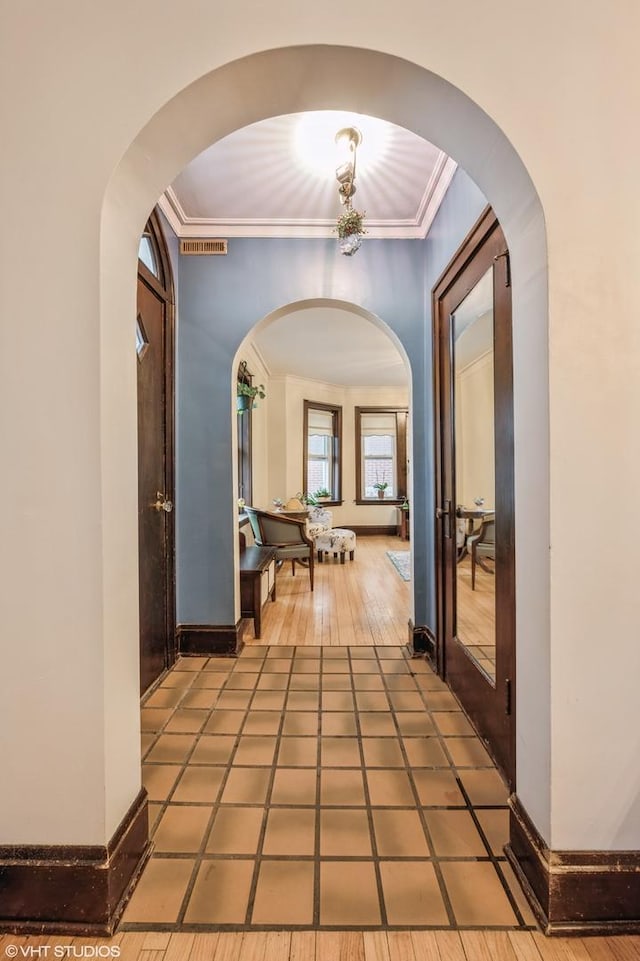 hall featuring crown molding and tile patterned flooring