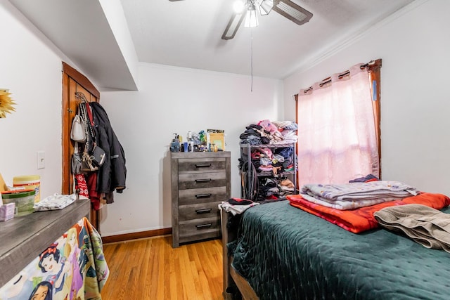 bedroom featuring ceiling fan, ornamental molding, and light hardwood / wood-style floors