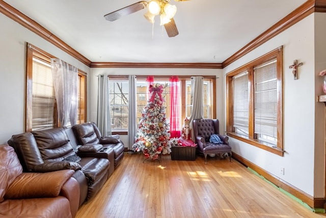 living room with ceiling fan, ornamental molding, and light hardwood / wood-style floors