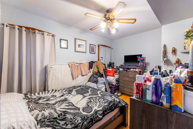 bedroom featuring wood-type flooring and ceiling fan