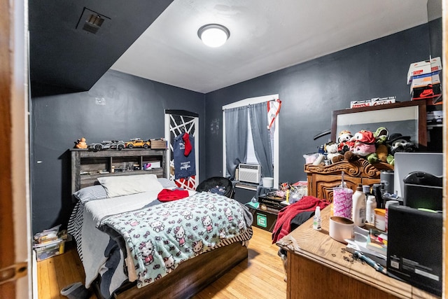 bedroom featuring cooling unit and hardwood / wood-style floors