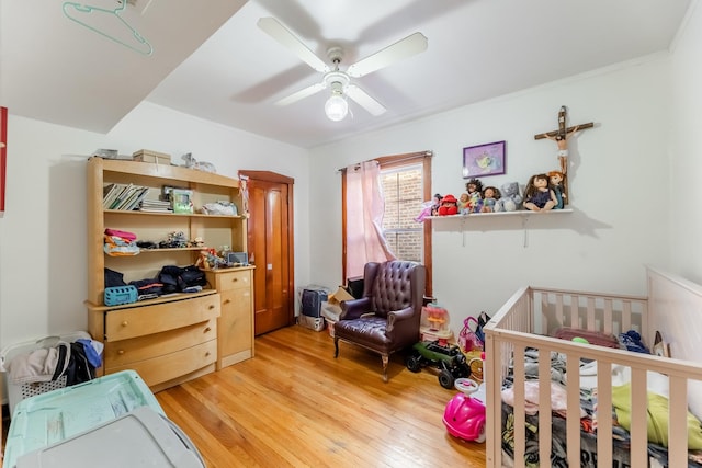 bedroom featuring light hardwood / wood-style floors and ceiling fan