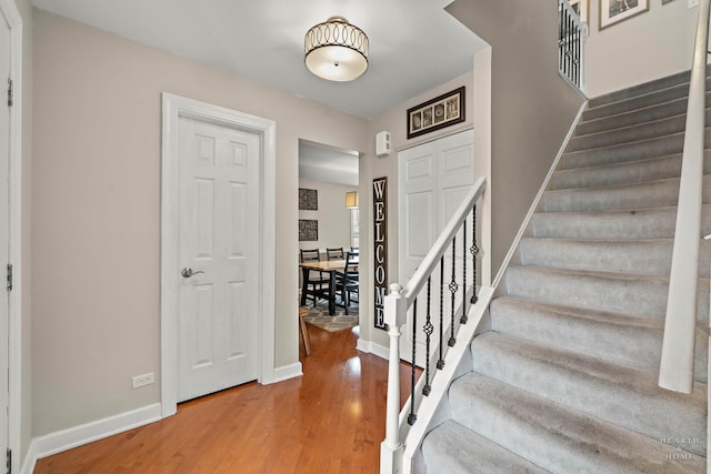 stairway featuring baseboards and wood finished floors