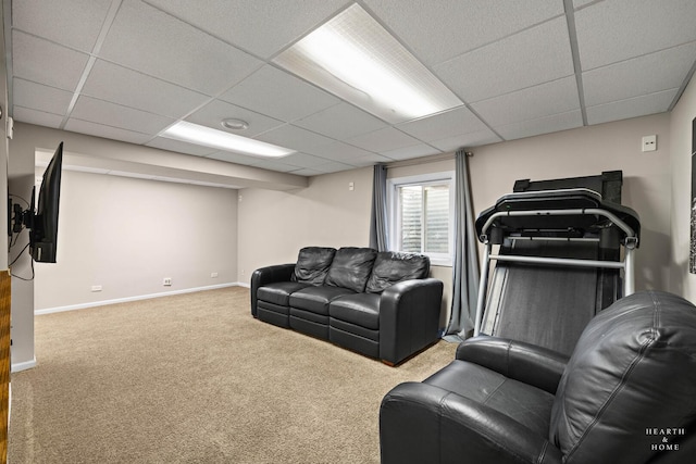 carpeted living area featuring a paneled ceiling and baseboards