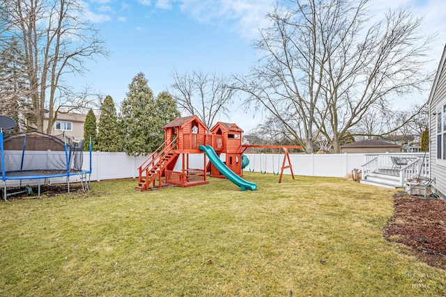 view of play area with a yard, a trampoline, and a fenced backyard