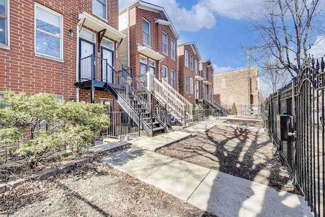 exterior space featuring a residential view and fence