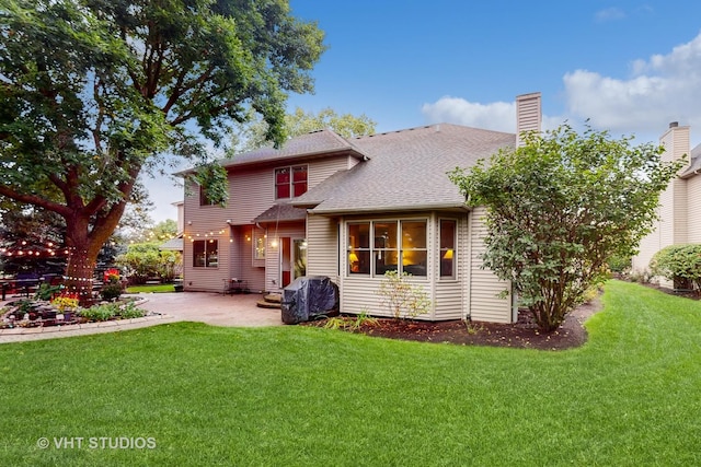 back of property featuring a yard and a patio