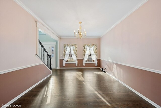 interior space featuring an inviting chandelier, ornamental molding, and dark wood-type flooring