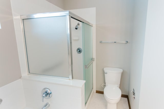 bathroom with toilet, a bathing tub, a shower stall, and baseboards