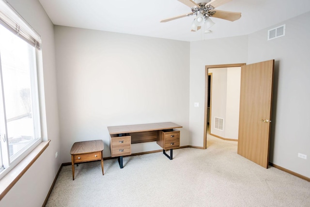 sitting room with carpet floors, a wealth of natural light, and visible vents