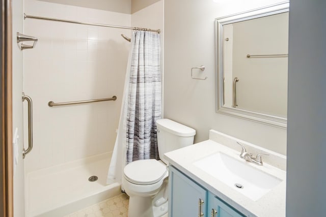 bathroom featuring a stall shower, vanity, and toilet