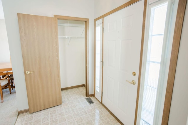 entrance foyer featuring light floors, visible vents, and baseboards