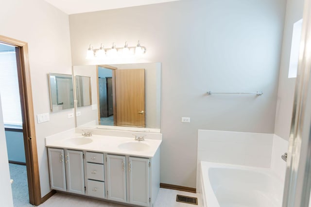 bathroom with vanity and a bathtub