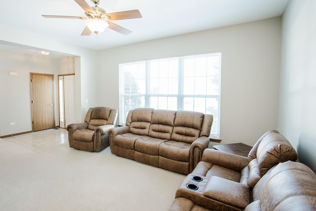 carpeted living room featuring ceiling fan