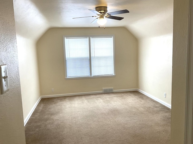 additional living space with lofted ceiling, carpet floors, visible vents, and baseboards