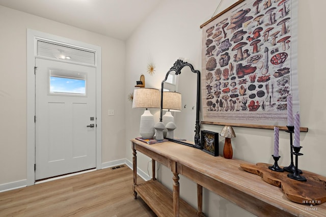 entryway featuring light wood finished floors, visible vents, and baseboards