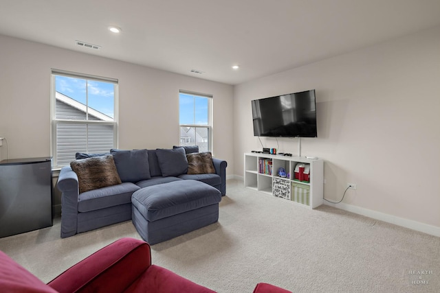 carpeted living room featuring recessed lighting, visible vents, and baseboards