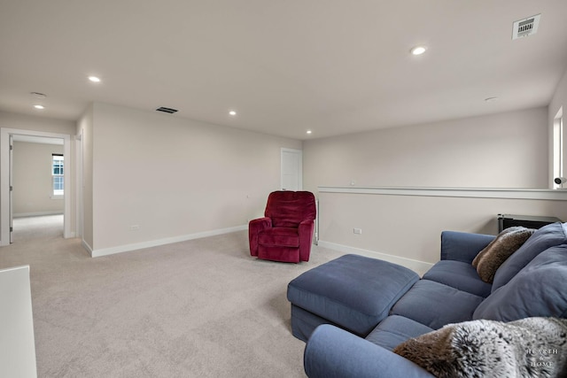 living room featuring light carpet, baseboards, visible vents, and recessed lighting