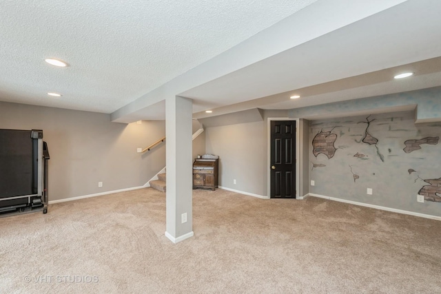 finished below grade area with baseboards, light colored carpet, stairs, a textured ceiling, and recessed lighting