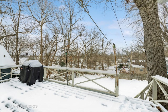 yard layered in snow featuring fence