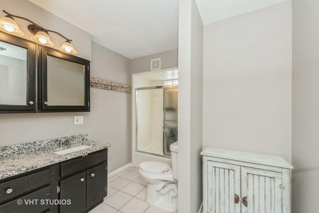 full bathroom with visible vents, toilet, tile patterned floors, combined bath / shower with glass door, and vanity