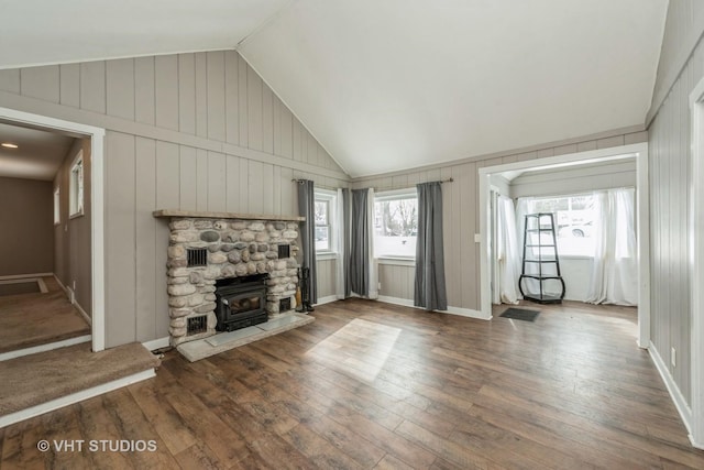 unfurnished living room with lofted ceiling, baseboards, and wood finished floors