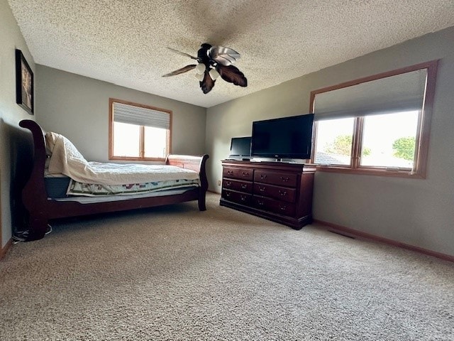 unfurnished bedroom with light carpet, a textured ceiling, and ceiling fan