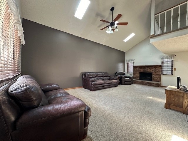 carpeted living room featuring a fireplace, high vaulted ceiling, and ceiling fan