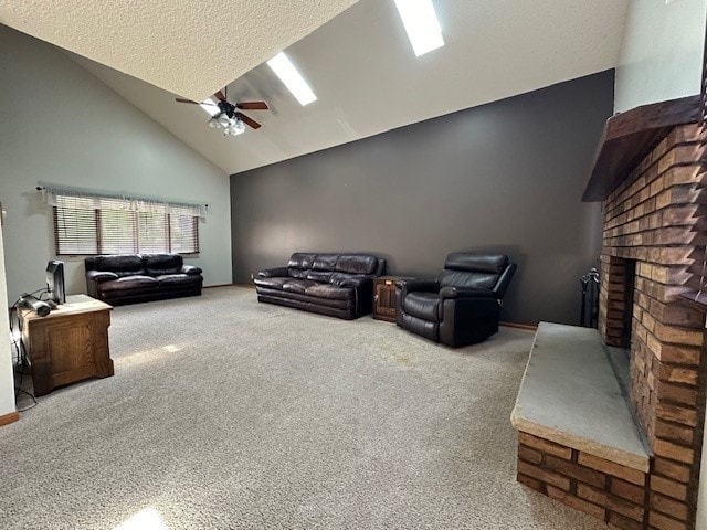 carpeted living room featuring a brick fireplace, high vaulted ceiling, a textured ceiling, and ceiling fan