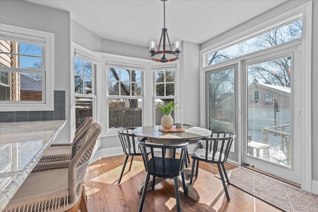 sunroom with a chandelier