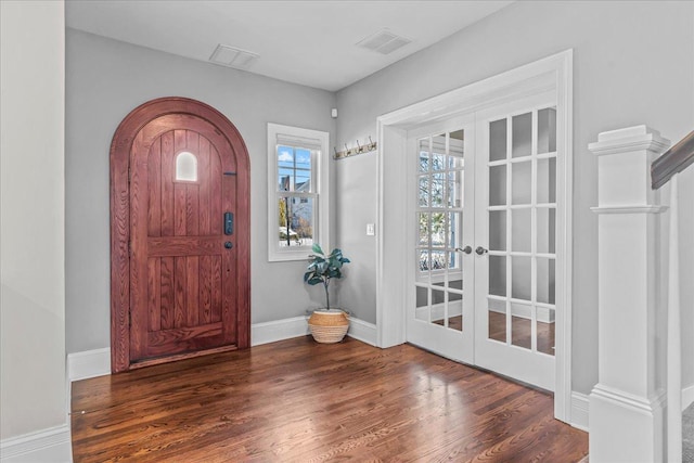 entrance foyer with french doors, dark wood finished floors, visible vents, and baseboards