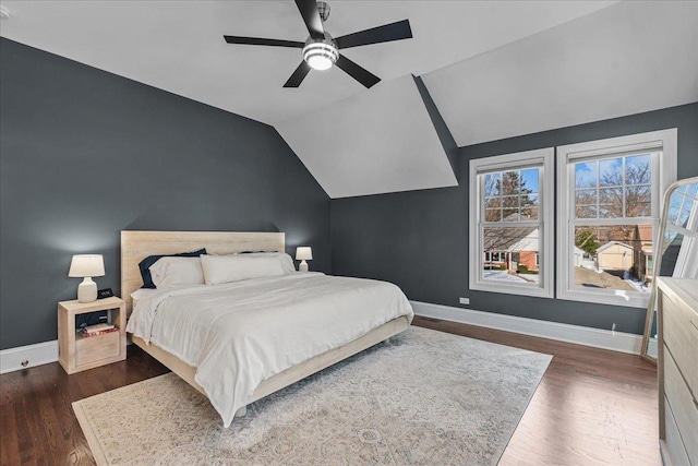 bedroom featuring vaulted ceiling, ceiling fan, dark wood-type flooring, and baseboards