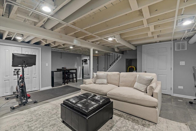 living room with visible vents, stairway, and baseboards