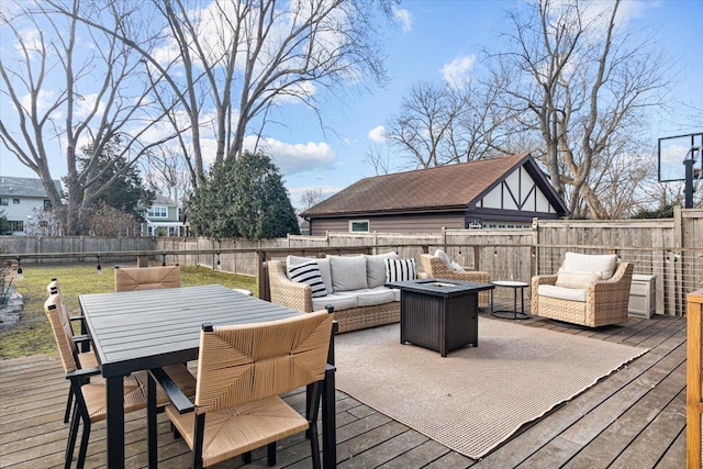 wooden deck featuring outdoor dining area, an outdoor living space with a fire pit, and a fenced backyard