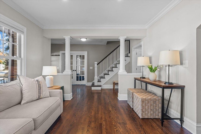 living room with decorative columns, baseboards, dark wood finished floors, stairway, and crown molding