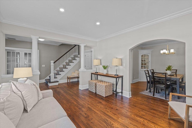 living room with baseboards, ornamental molding, stairway, dark wood finished floors, and decorative columns