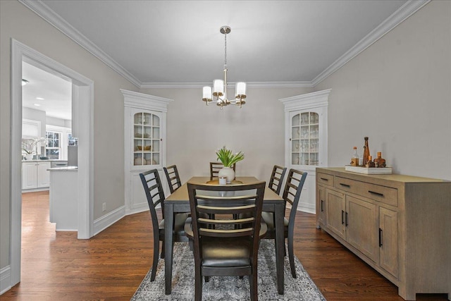 dining area with ornamental molding, dark wood finished floors, and an inviting chandelier