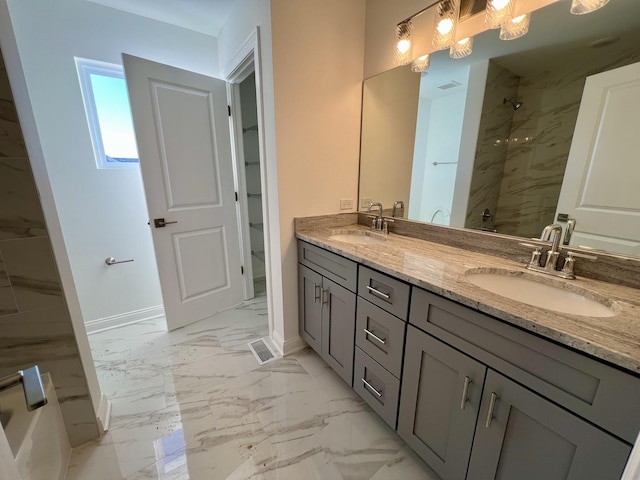 bathroom with vanity and a tile shower