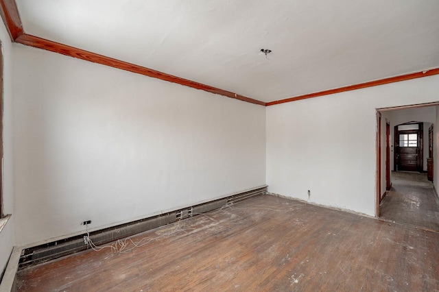 unfurnished room with dark hardwood / wood-style flooring and ornamental molding