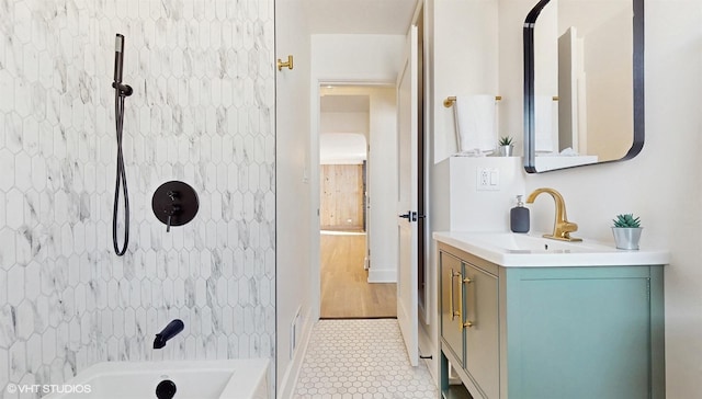 bathroom with vanity, tiled shower / bath, and tile patterned floors