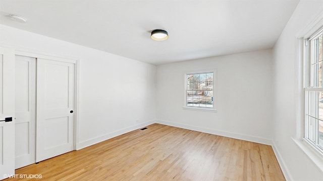 empty room with hardwood / wood-style floors