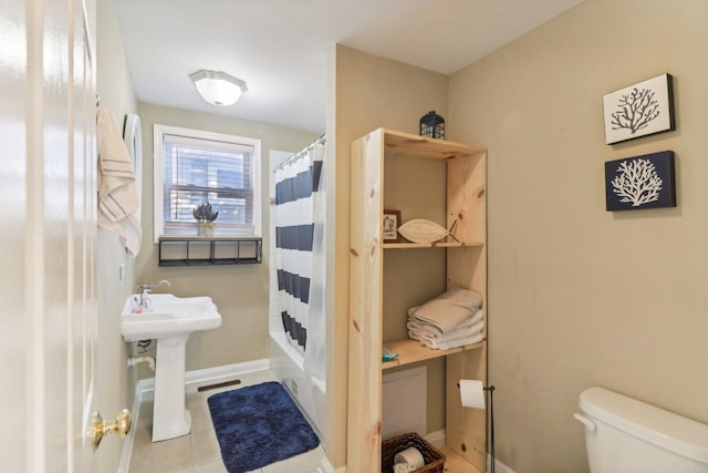 bathroom featuring shower / bath combo, tile patterned floors, and toilet