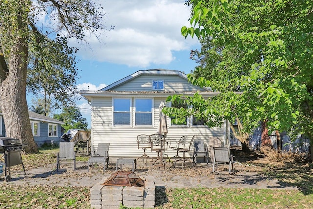 back of house featuring a fire pit