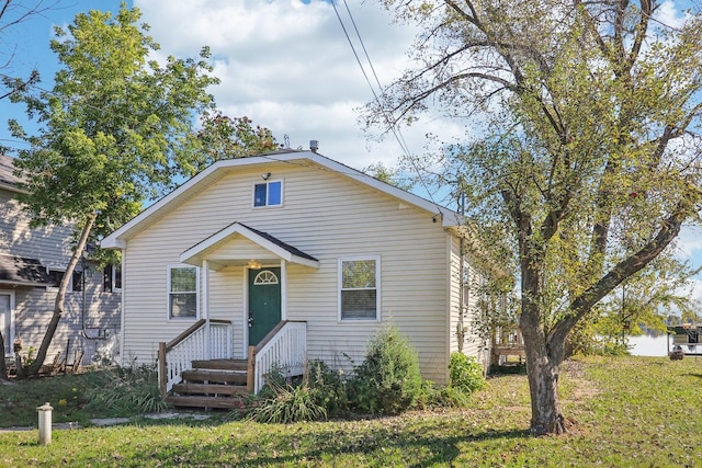 bungalow-style home with a front lawn