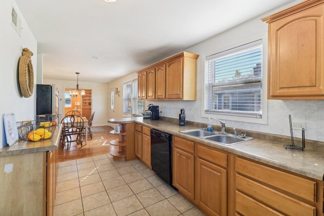 kitchen with sink, a chandelier, hanging light fixtures, light tile patterned floors, and dishwasher